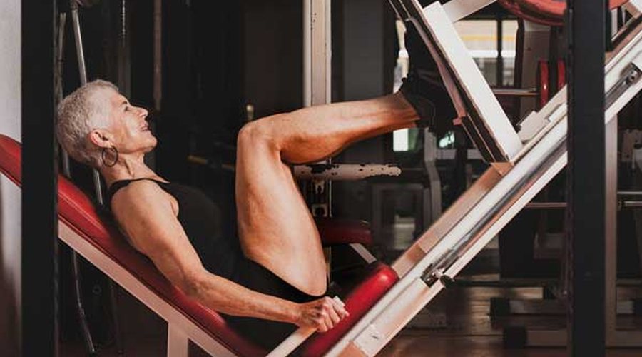 A senior man training his legs on a leg press machine