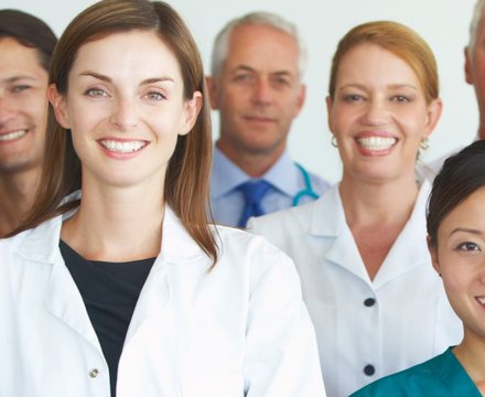 A smiling team of doctors and nurses